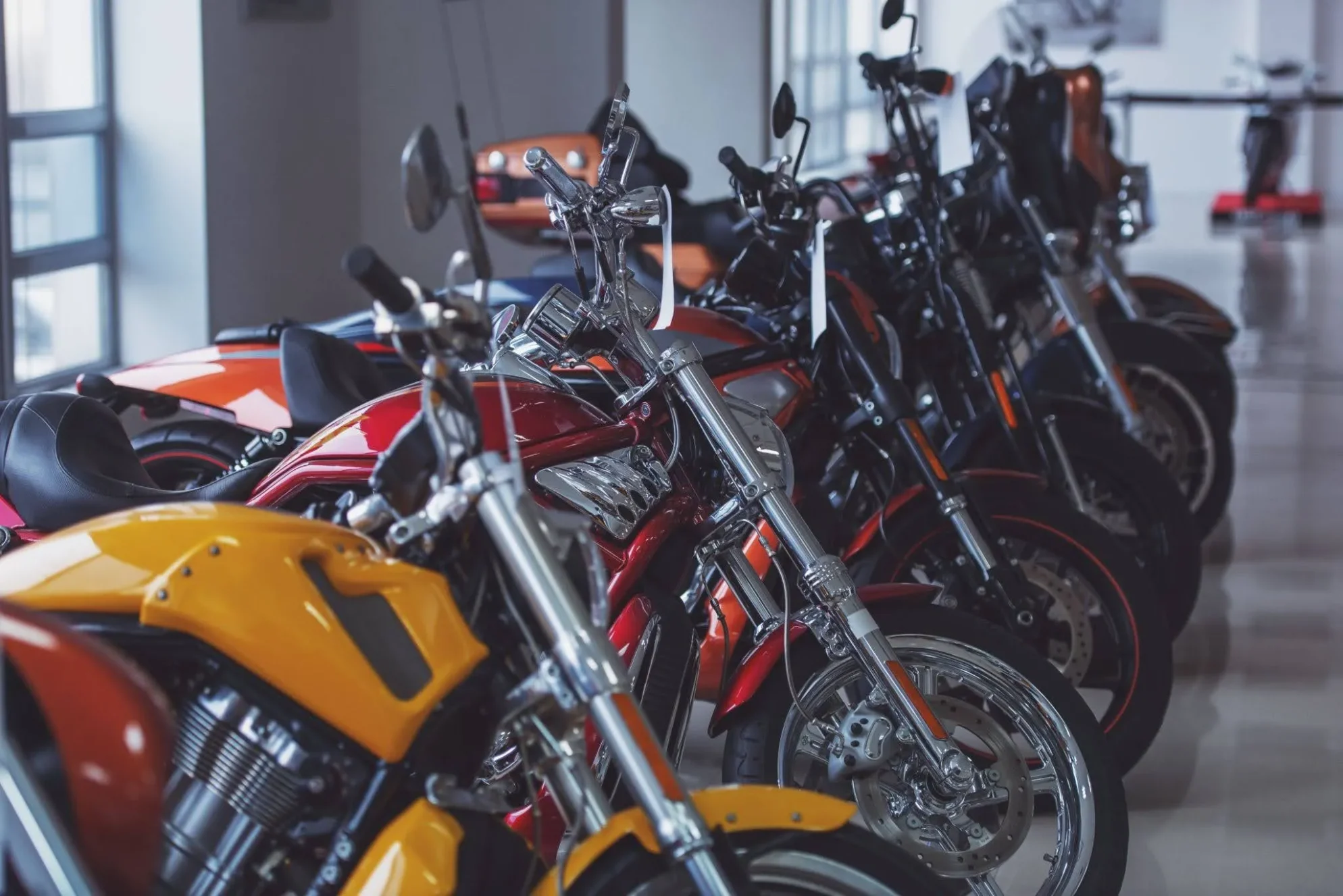 Interstate motorcycle shipping for a row of polished motorcycles parked in an indoor showroom