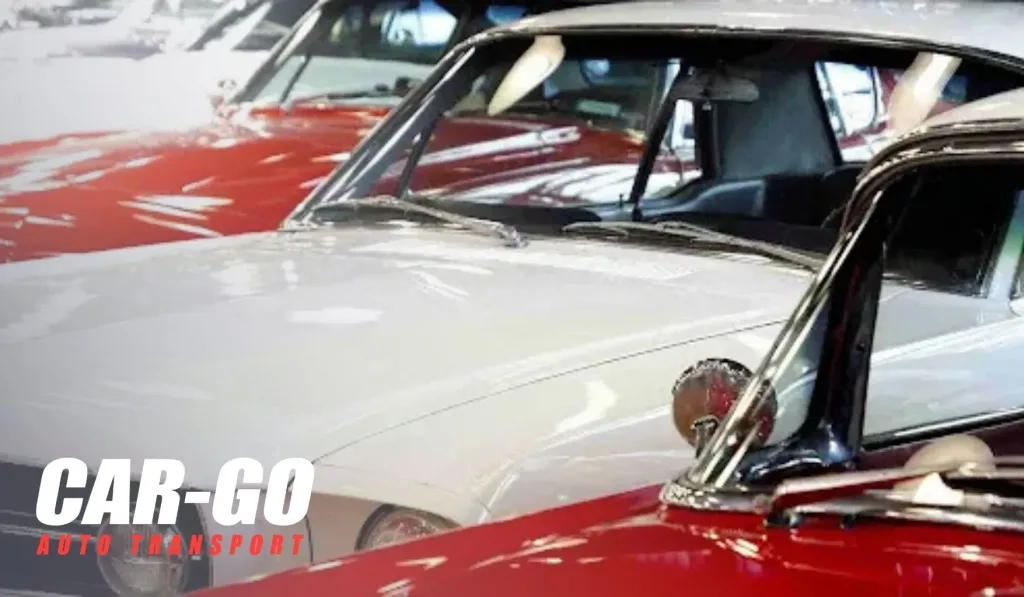 Classic cars parked indoors awaiting transport, illustrating how to ship a non-running car with specialized handling.