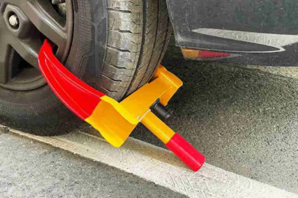 How to Ship a Non-Running Car Long Distance Wheel dolly secured under a car tire, used to ship a non-running car that cannot be driven or steered.