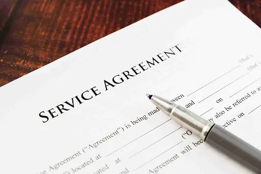 Vehicle Shipping for Employee Relocations: A Guide Signed service agreement document outlining terms for vehicle shipping for employee relocations and corporate transfer services.