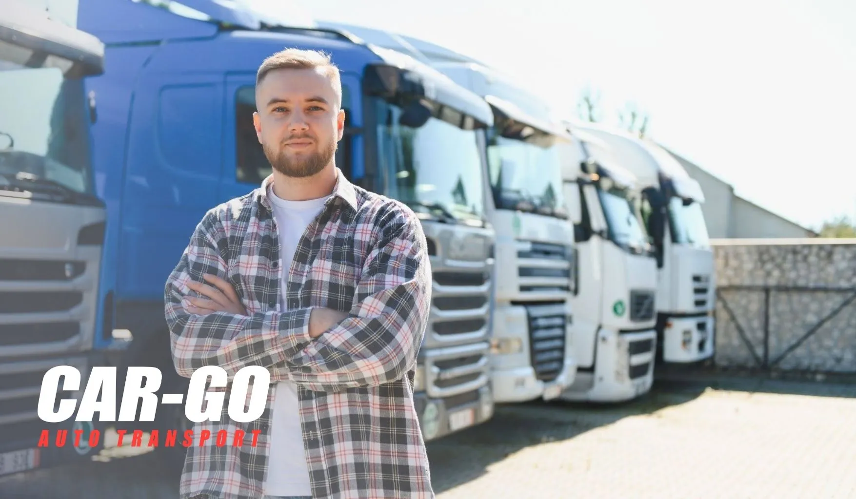 Auto transport broker vs carrier driver standing with crossed arms in front of a fleet of transport trucks