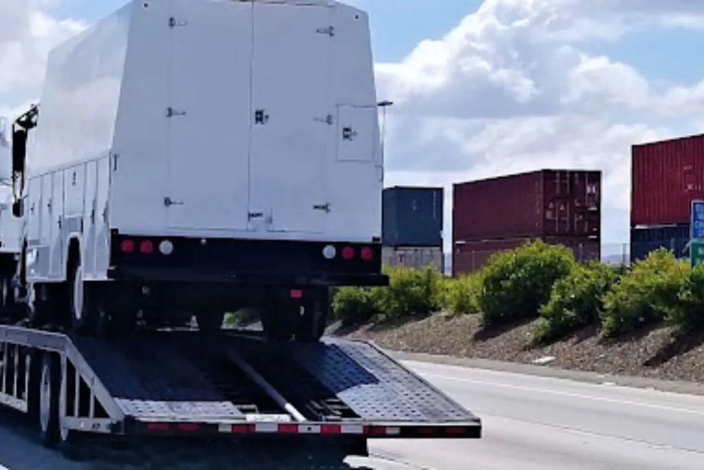 How Long Does It Take to Ship a Car? Average Timelines for Every Route Vehicle loading onto transport carrier demonstrating pickup timelines for How Long Does Car Shipping Take.