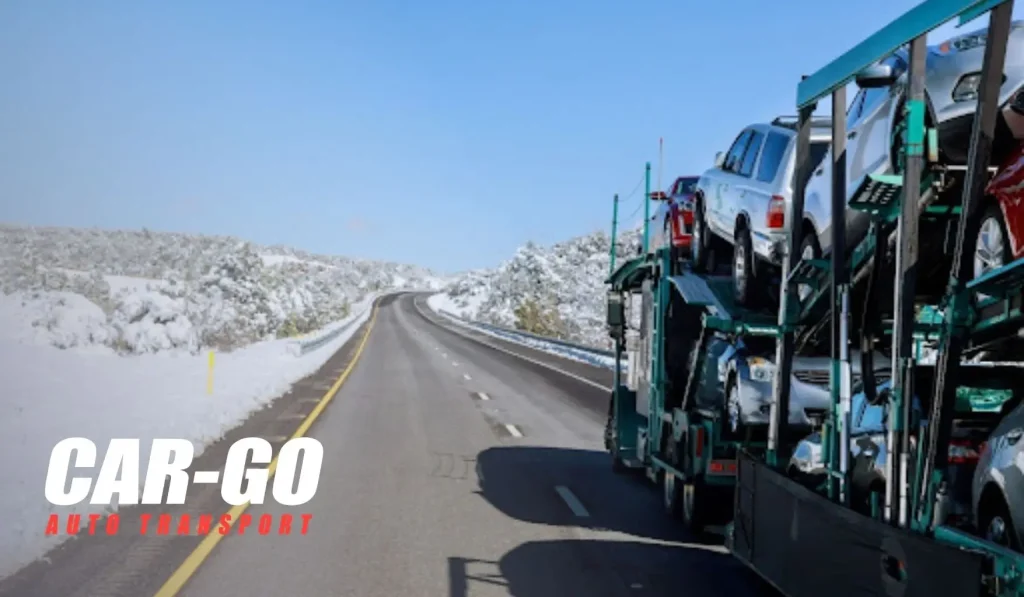 Car carrier transporting vehicles through snowy highway for snowbird car shipping to Florida during winter travel.