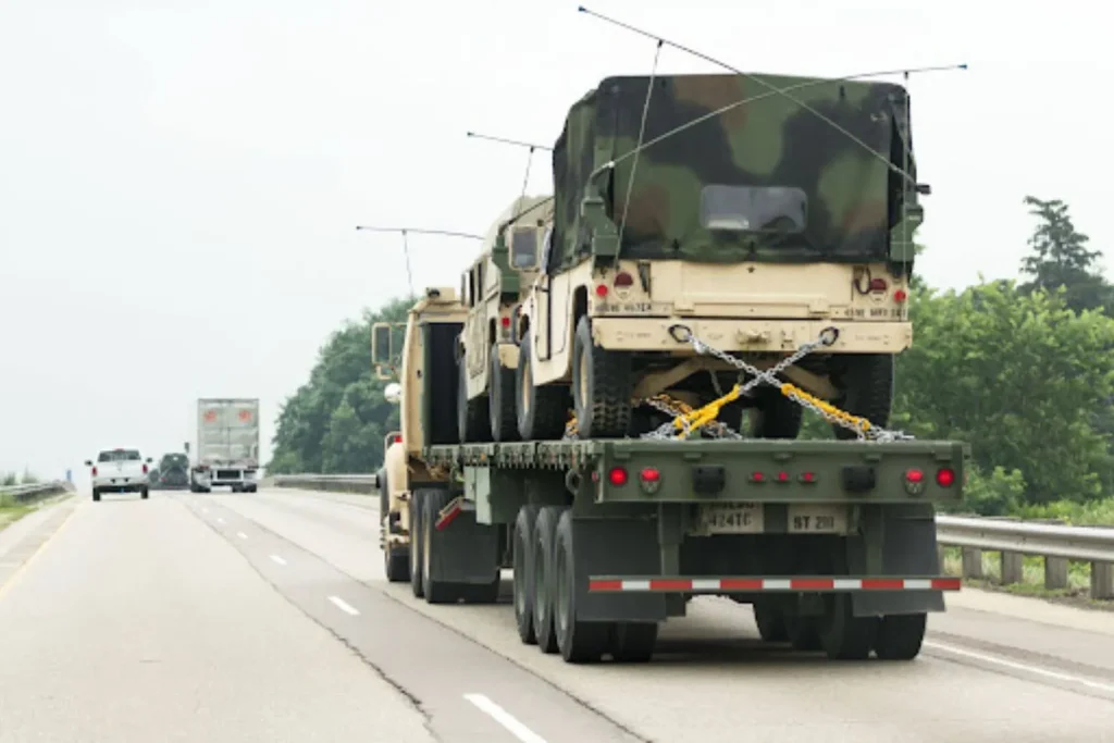 How Government Agencies Procure Vehicle Transport Services Government Agencies Procure Vehicle fleet transport with military vehicles secured on a commercial auto carrier.